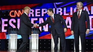Republican U.S. presidential candidate businessman Donald Trump (L) shakes hand with Senator Ted Cruz (C) as he arrives onstage with Cruz and former Governor Jeb Bush (R) before the start of the Republican presidential debate in Las Vegas, Nevada December 15, 2015. REUTERS/David Becker