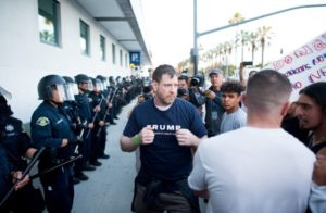 A man leaving a campaign rally for Republican presidential candidate Donald Trump squares off against protesters following him on Thursday, June 2, 2016, in San Jose, Calif. A group of protesters attacked Trump supporters who were leaving the presidential candidate's rally in San Jose on Thursday night. A dozen or more people were punched, at least one person was pelted with an egg and Trump hats grabbed from supporters were set on fire on the ground. (AP Photo/Noah Berger)